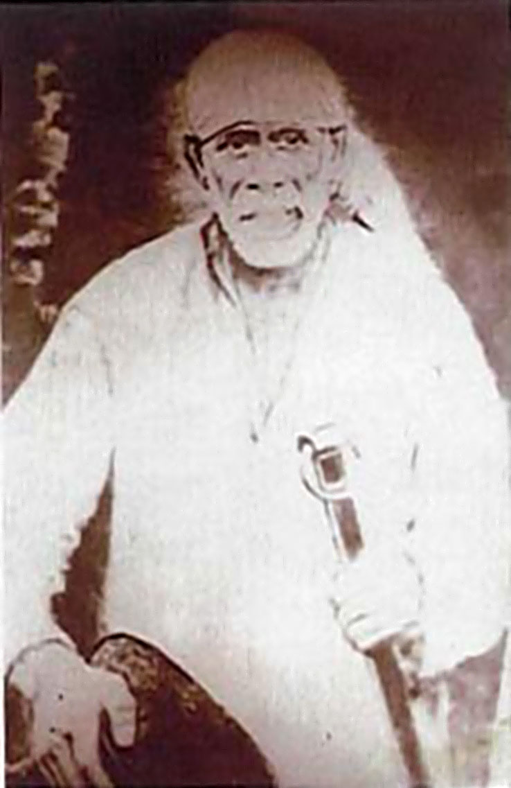 Shirdi Sai Baba, seated, holding his satka